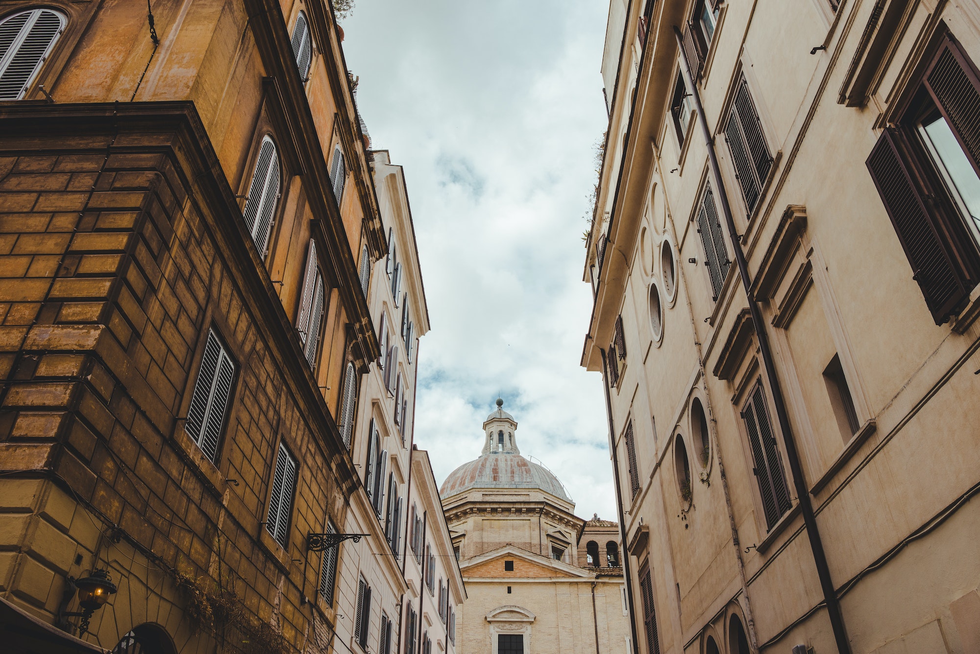old buildings on street of Rome with cathedral on background, Italy