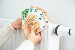 Radiator with thermostat and euro money banknotes.